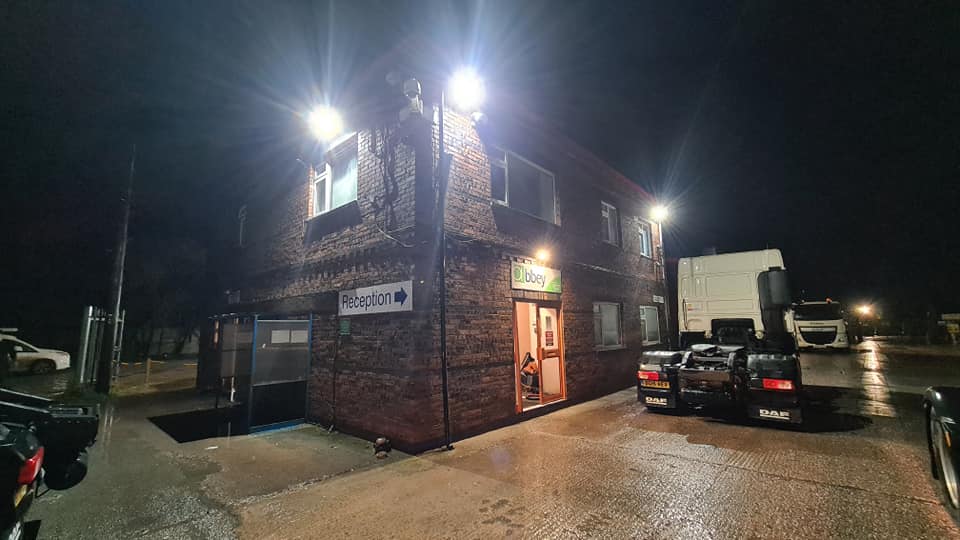 Commercial building lit at night by floodlights fitted by Rogan Electrical Services