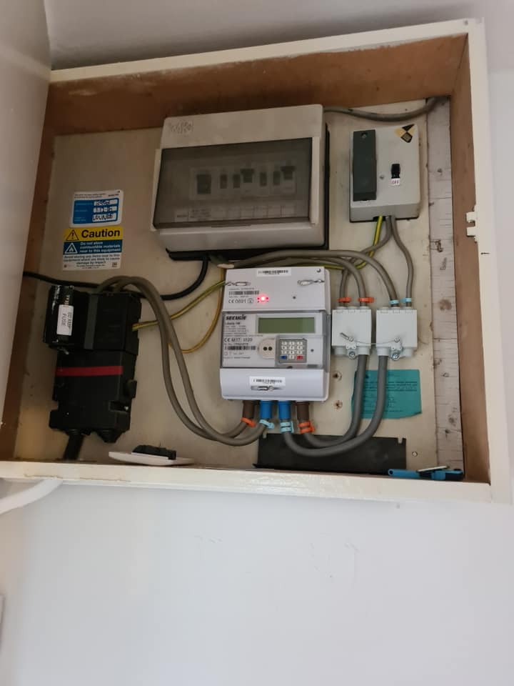A meter cupboard with consumer unit, meter and isolator