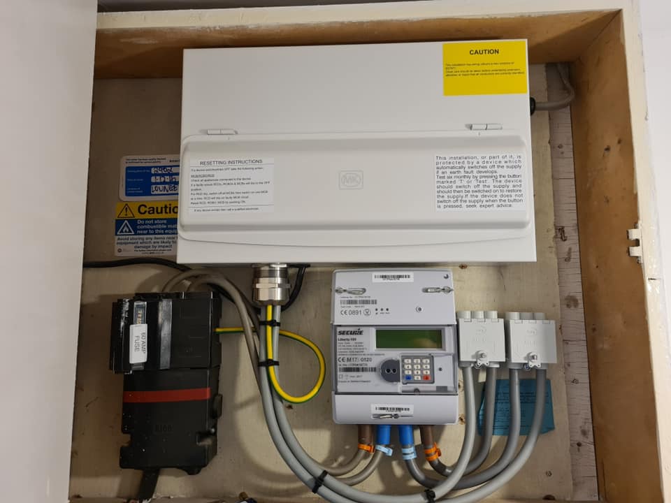 A new metal consumer unit fitted in a meter cupboard