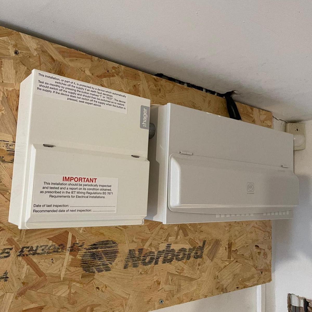 Two new consumer units mounted on an OSB board