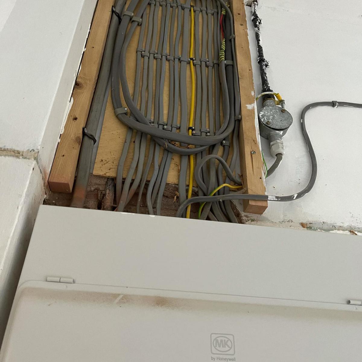 Cable runs gathered into a consumer unit position