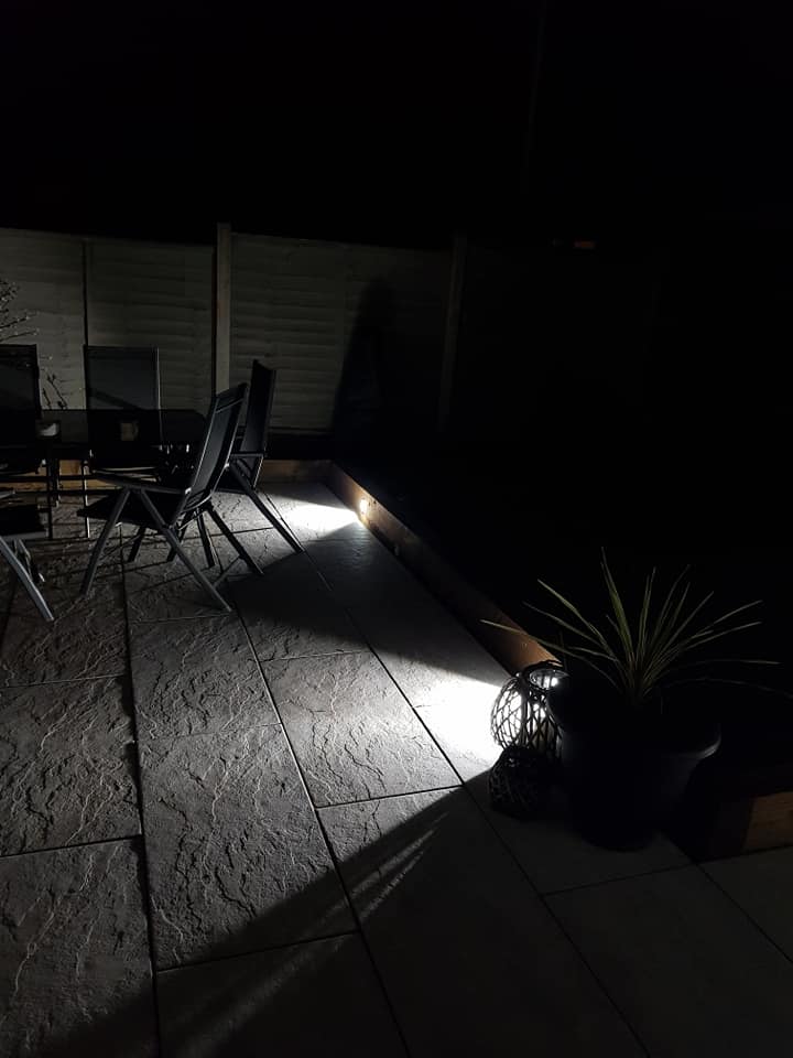 Patio seating at night with low-level lighting
